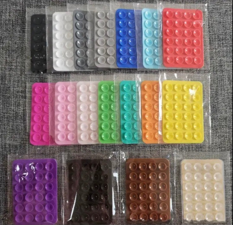 24 Compact Silicone Phone Holders with Suction Cups, Designed for Smartphones And Compatible with Different Surfaces. They Are Sturdy, Waterproof, Easy to Apply, And Have a Non-Slip Feature.